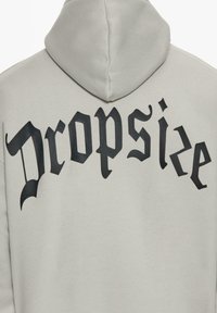 Light gray hoodie featuring large black Gothic-style text "Dropsize" across the back, with a soft, textured fabric and a hood.