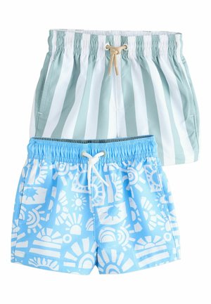 Deux paires de shorts de bain, l'une avec des rayures verticales vertes et blanches et un cordon beige, l'autre bleu clair avec des motifs de soleil blancs et un cordon blanc.