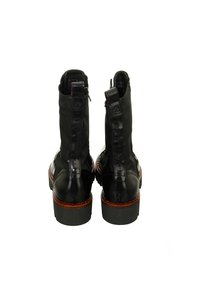 Black ankle boots made of leather with a smooth finish, featuring a zip closure at the back and a chunky rubber sole with a textured pattern.