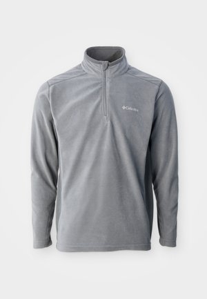 Vaaleanharmaa fleece-poolopaita pitkine hihoineen ja neljänneksen mittaisella vetoketjulla edessä, vasemmalla rinnalla pieni valkoinen Columbia-logo.