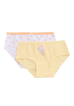 Dos pares de calzoncillos infantiles; uno de color amarillo pálido con un estampado de unicornio en un cono de helado, y el otro blanco con un patrón de lunas crecientes color durazno y estrellas.