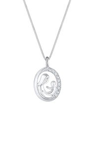 Pendentif en argent présentant un design stylisé de mère et enfant, entouré de cristaux transparents, suspendu à une fine chaîne.
