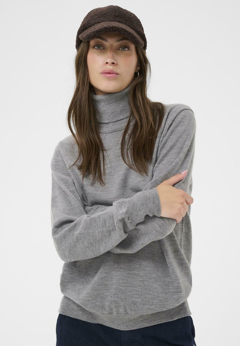 Gray turtleneck sweater made of a soft material, featuring a relaxed fit and ribbed hems. Worn with a brown textured cap.