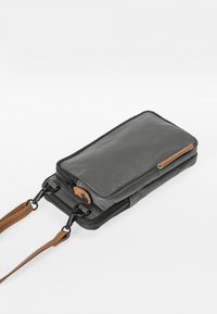Gray leather crossbody bag with a smooth texture, zip closure, and a brown leather accent. Features detachable straps for versatile use.