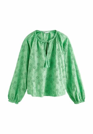Blouse verte à manches longues avec broderie ajourée florale, poignets élastiques et lien à l'avant avec pompons.