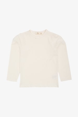 Fehér, hosszú ujjú ing, puha pamutból készült. Pikkelyes nyakkivágással, apró masni díszítéssel és gumírozott mandzsettákkal rendelkezik. Sima textúra.