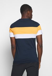 Short-sleeve T-shirt featuring horizontal stripes in navy, yellow, white, and grey. Made from soft cotton, with a relaxed fit and crew neck.