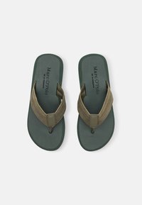 Green flip-flops with a textured sole, suede straps, and a dark green base. Features branding on the insole and dual-tone color scheme.