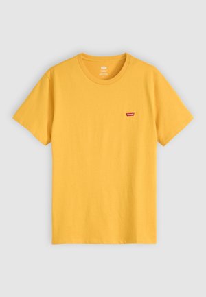 T-shirt en coton jaune à manches courtes avec un col rond et un petit logo rouge Levi's sur la poitrine gauche.