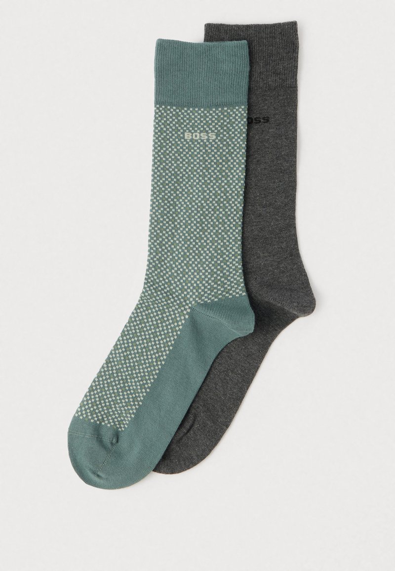 Dois pares de meias: um em verde-azulado com um padrão texturizado e o outro em cinza escuro sólido. Ambos apresentam tecido de malha e punhos contrastantes.