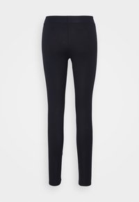 Zwarte leggings gemaakt van rekbare stof, met een gladde textuur en een strakke pasvorm. De tailleband is breed en elastisch.