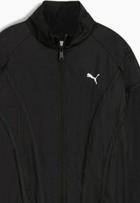 Black athletic jacket with a high collar, front zipper, textured fabric, and white Puma logo on the left chest area.