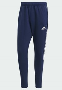 Navy blue sweatpants with an elastic waistband, side pockets, and white Adidas logo. Tapered leg design with vertical white stripes.