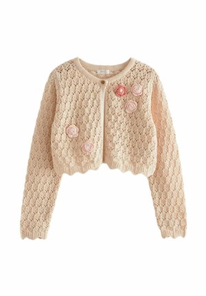 Beige gebreide cropped cardigan met lange mouwen, gegolfde randen, sluiting met één knoop en roze en rode bloemapplicaties aan de voorkant.