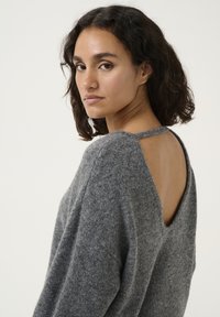 Gray wool sweater featuring a wide open back design and a subtle tie detail. The fabric has a soft, textured appearance.