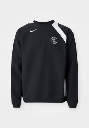 Svart hettegenser med hvite detaljer, rund halslinning, lange ermer og ribbestrikkede mansjetter. Har Nike-logo og sirkulært Chelsea FC-emblem.