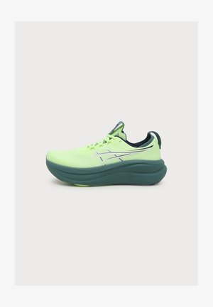 Chaussure de course vert néon avec semelle épaisse vert foncé, bandes blanches croisées sur les côtés, lacets et languette au talon sur fond blanc.
