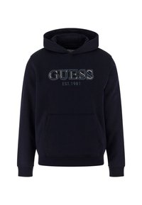 Tengerészkék kapucnis pulóver elülső zsebbel, kiemelkedő "GUESS" logóval és "EST.1981" felirattal, ellentétes színekben. Puha szövet tapintás.