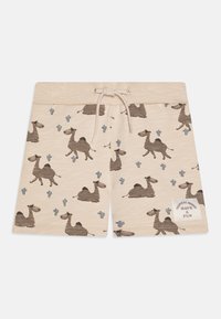 Beiga shorts med ett mönster av kamel och kaktus i brunt och grått, med en texturerad midja och dragsko; inkluderar en tagg med "TROPICAL MOOD."