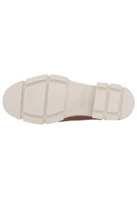 White rubber sole of a shoe with a textured finish, featuring rectangular patterns and slight curvature at the toe area. Brand name visible.