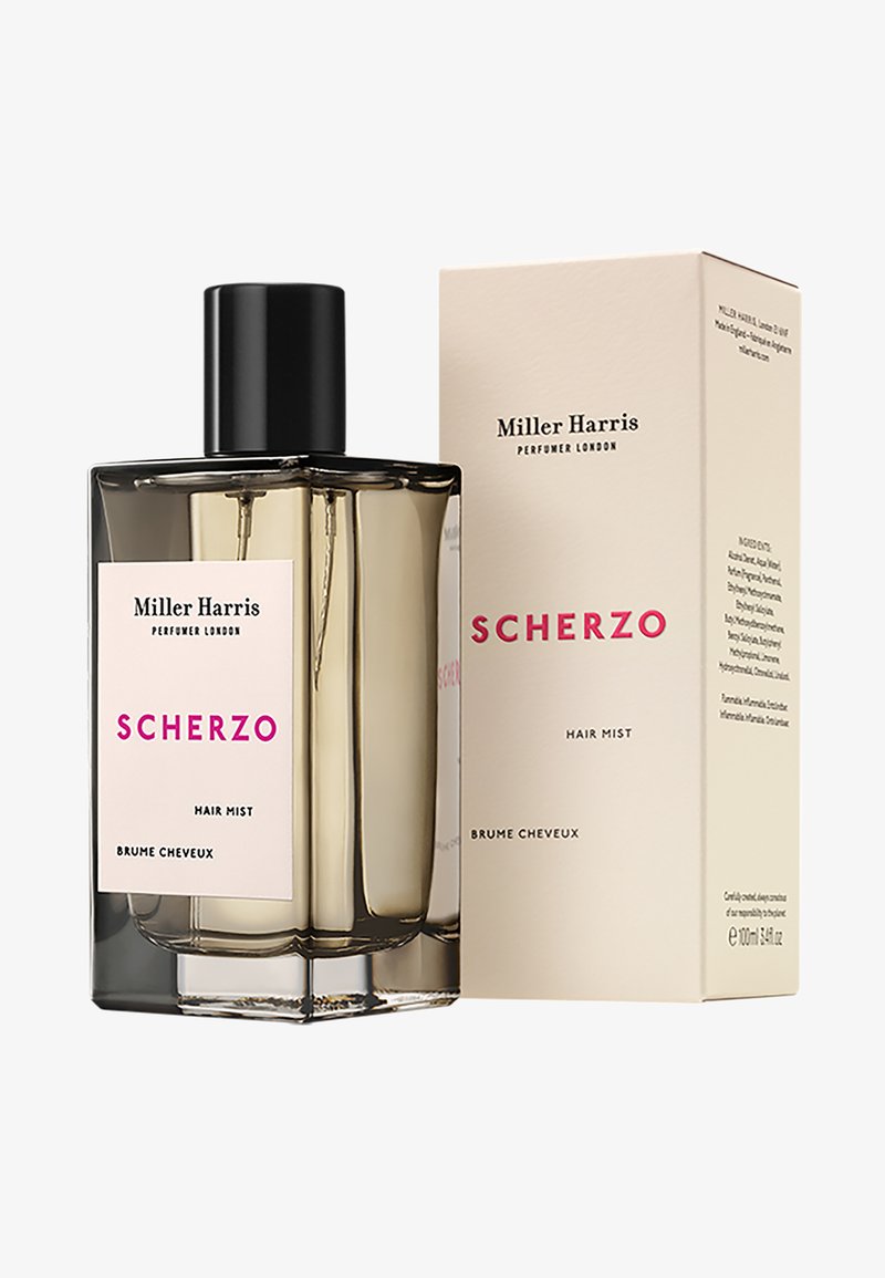 Haarnebel-Flasche aus klarem Glas mit schwarzem Deckel, versehen mit einem rosa Etikett mit "SCHERZO" in fettem Text. Begleitet von einer beigen Box.