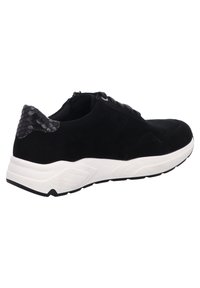 Black suede sneaker with a textured black accent at the heel, featuring a white midsole and black outsole. Laces for secure fit.