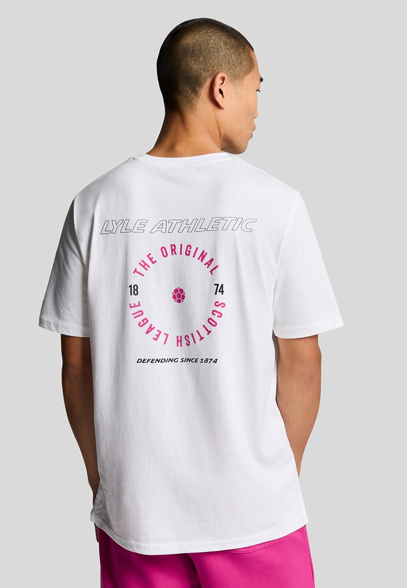 Hvit bomull T-skjorte med en rund grafikk i rosa og svart på baksiden, med teksten "LYLE ATHLETIC" og "SCOTTISH LEAGUE."