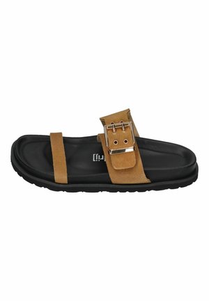 Black footbed sandal with two tan suede straps, one with a large gold buckle, and a textured black sole.