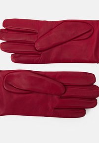 Red leather gloves featuring a smooth texture, five-finger design, and a snug fit. The leather has subtle creases and stitches.