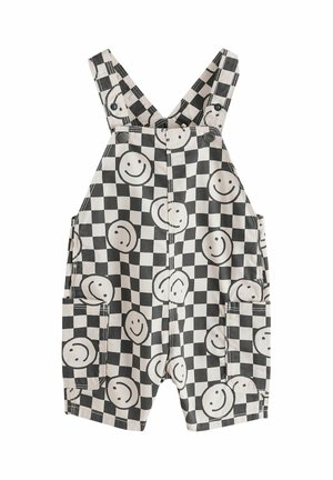 Sort-hvide ternede korte overalls med store smilende ansigtsprint og forlommer, med knappede stropper.