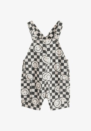 Juodi ir balti languoti trumpi kombinezonai su dideliais šypsenėlės atspaudais ir priekinėmis kišenėmis, su sagomis užsegamomis petnešomis.