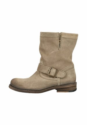 Light brown suede ankle boot with a strap and buckle detail, low stacked wooden heel, and a side slit near the top.