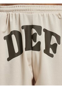 DEF PRINT  - Jogginghose - beige