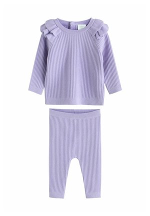 Lilla ribstrikket top med flæseaccenter ved skuldrene og matchende ribstrikkede leggings. Blød tekstur og afslappet pasform for komfort.