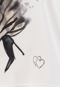 White fabric featuring a black high-heeled shoe illustration with subtle grey accents. Silver studded heart detail near the hem.