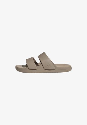 Cloudfoam slide sandals, beige, featuring two wide straps, a cushioned footbed, and a textured sole for grip. Simple, smooth design.