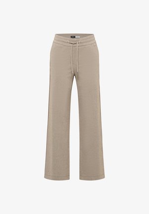 Beige weite Jogginghose mit Kordelzug, aus weichem Stoff. Mit zwei Seitentaschen und einer strukturierten Oberfläche.