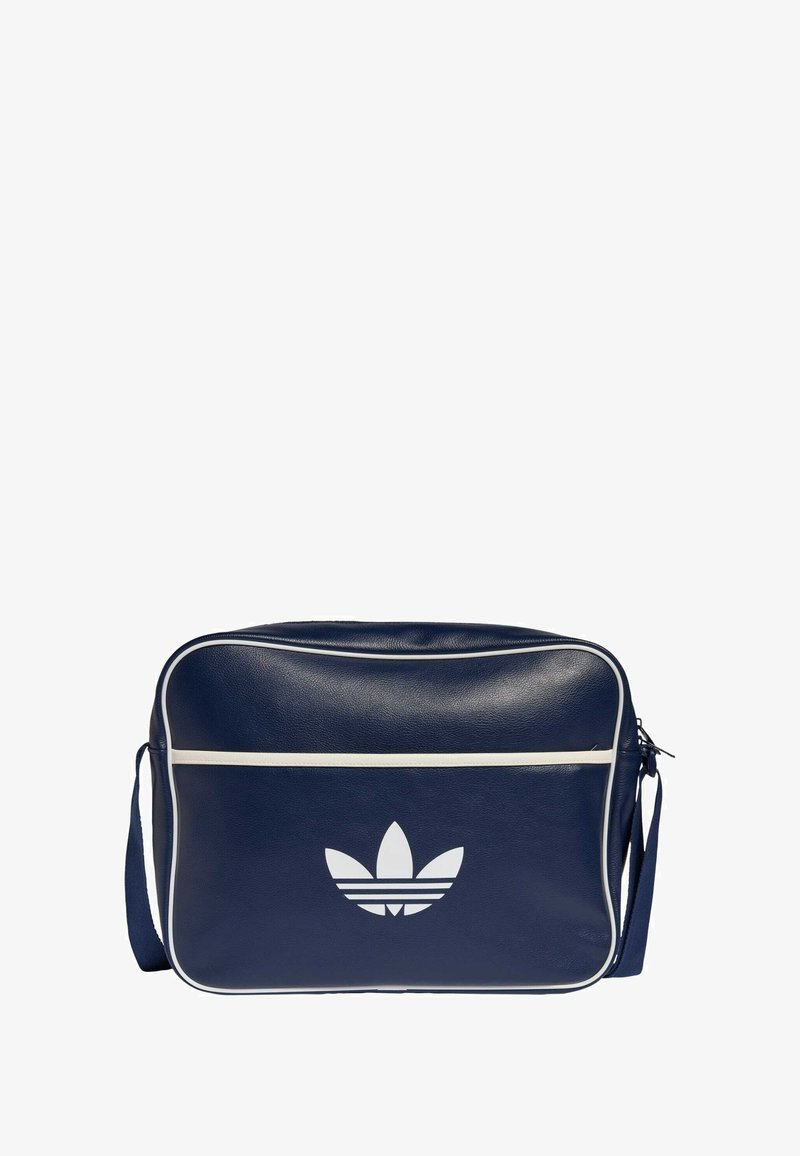 Niebieska syntetyczna torebka na ramię z białymi akcentami, ozdobiona przednim logo i zamkiem błyskawicznym. Prostokątny kształt z fakturowaną powierzchnią.