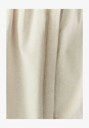 Light beige fabric with a textured finish, featuring soft, flowing drapes and subtle creases. Plain design without patterns or accents.