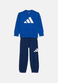 Blue sweatshirt with a white Adidas logo, paired with navy sweatpants featuring a white logo. Soft fabric, relaxed fit, elastic cuffs.
