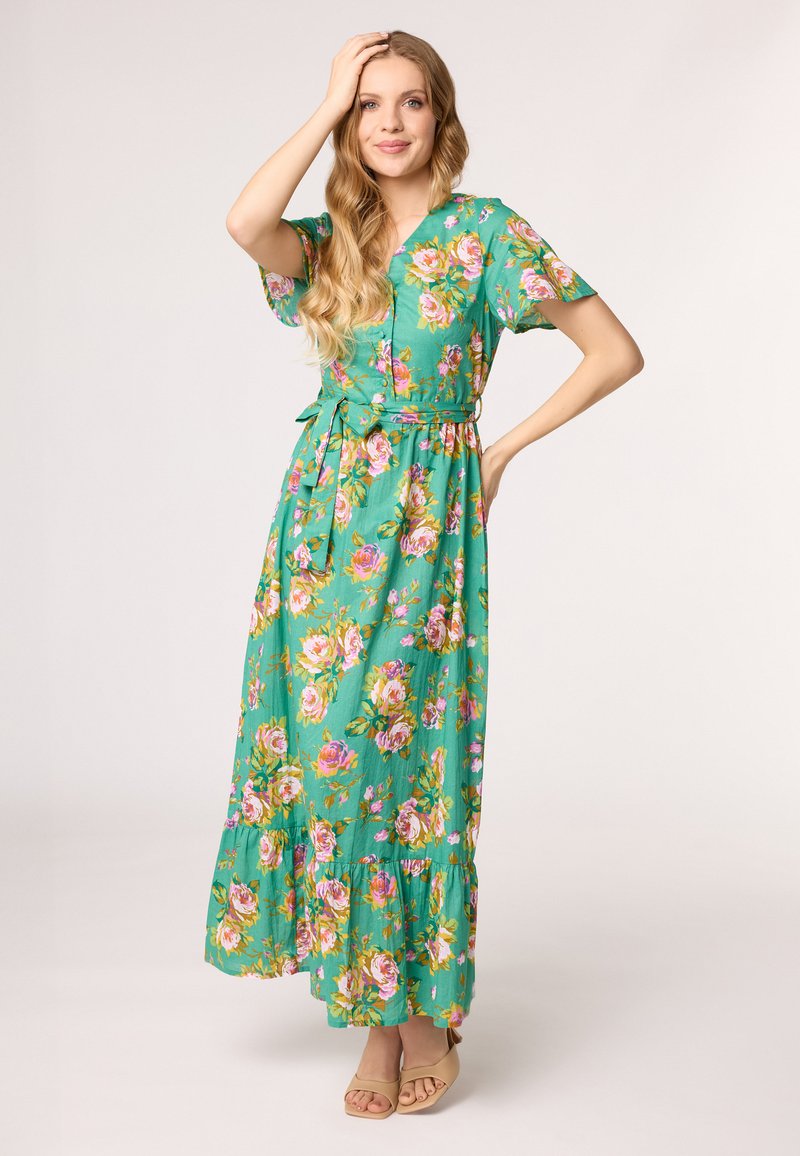 Blumenkleid in grüdem Stoff mit kurzen Ärmeln, V-Ausschnitt, taillierter Taille und vollem Saum. Mit rosa und gelben Rosenmuster.