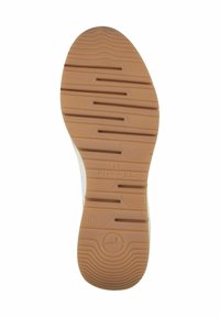 Tan rubber zool met gemarmerde groeven en patronen. Gestempeld met "TOMS" en maat "37". Glad rand die naar de bovenkant van de schoen leidt.
