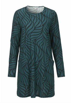 Langarm tuniek in teal met een zwart bladerenpatroon. Kenmerkt een ronde halslijn en heeft voorzakken. Zachte stof met een casual pasvorm.