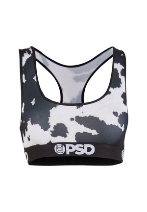 Soutien-gorge de sport à imprimé vache noir et blanc avec un design dos nageur et une bande élastique noire arborant le logo PSD blanc.