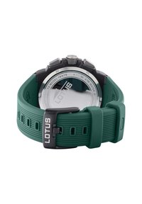 Orologio con cinturino in silicone verde e cassa in metallo argento. Presenta un design testurizzato, una corona di grandi dimensioni e un retro in vetro trasparente che mostra "LOTUS."