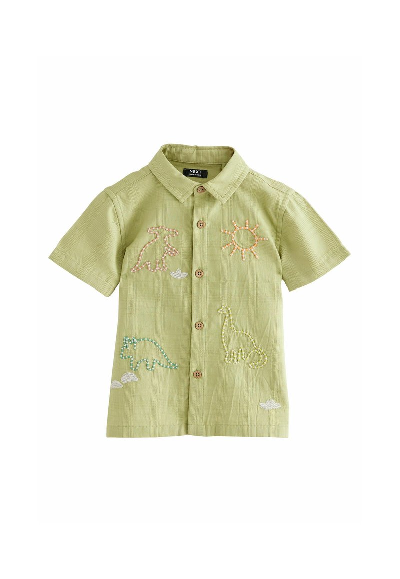 Chemise verte à manches courtes avec des dinosaures brodés et des motifs de soleil, fermeture avant à boutons, tissu texturé et col structuré.