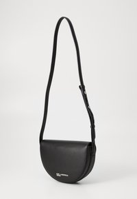 Borsa a tracolla in pelle sintetica nera con una forma curvata a mezzaluna e tracolla regolabile; presenta un logo argentato sul davanti.
