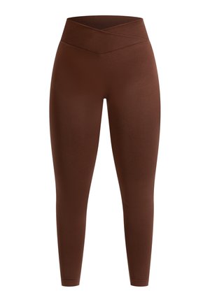 Braune, hoch taillierte Leggings aus glattem Material mit einem Kreuzgurt-Design, das eine figurbetonte Silhouette bietet.
