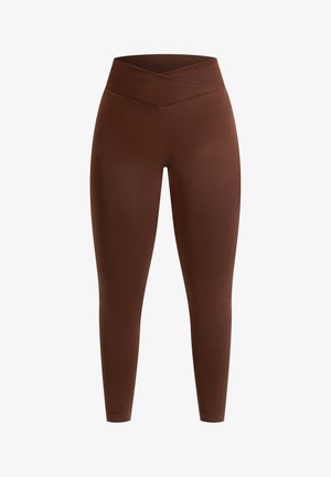 Brown high-waisted leggings made of smooth material with a crisscross waistband design, providing a fitted silhouette.