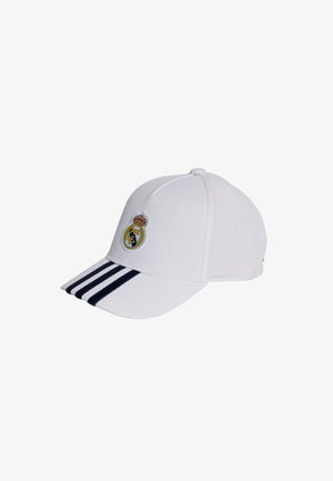 White baseball cap with navy stripes on the brim, featuring an embroidered Real Madrid logo on the front. Made of durable fabric.